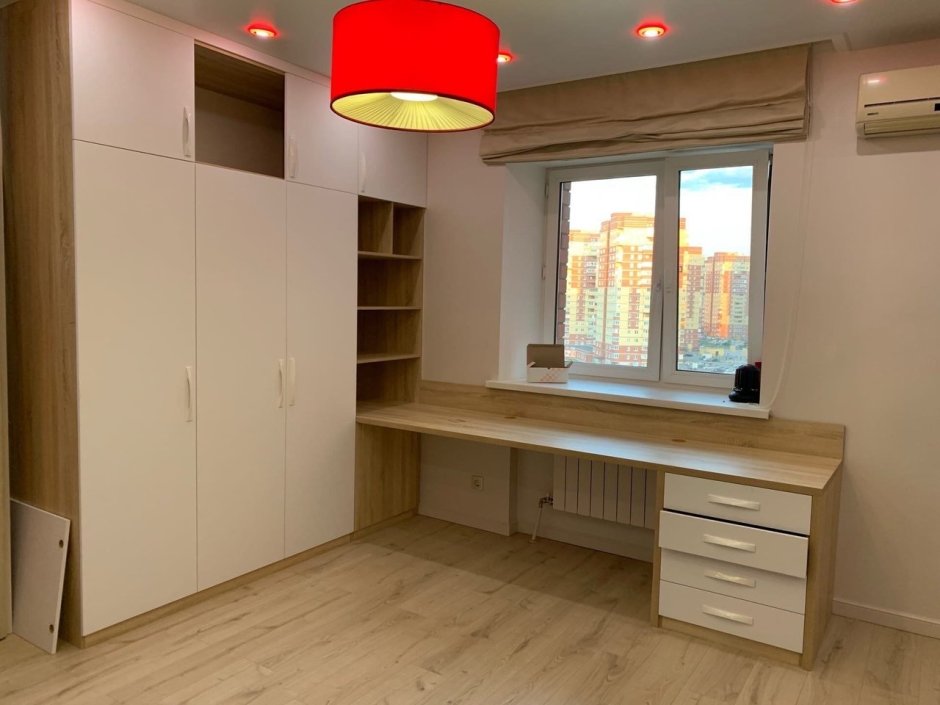 Письменный стол у окна со шкафами